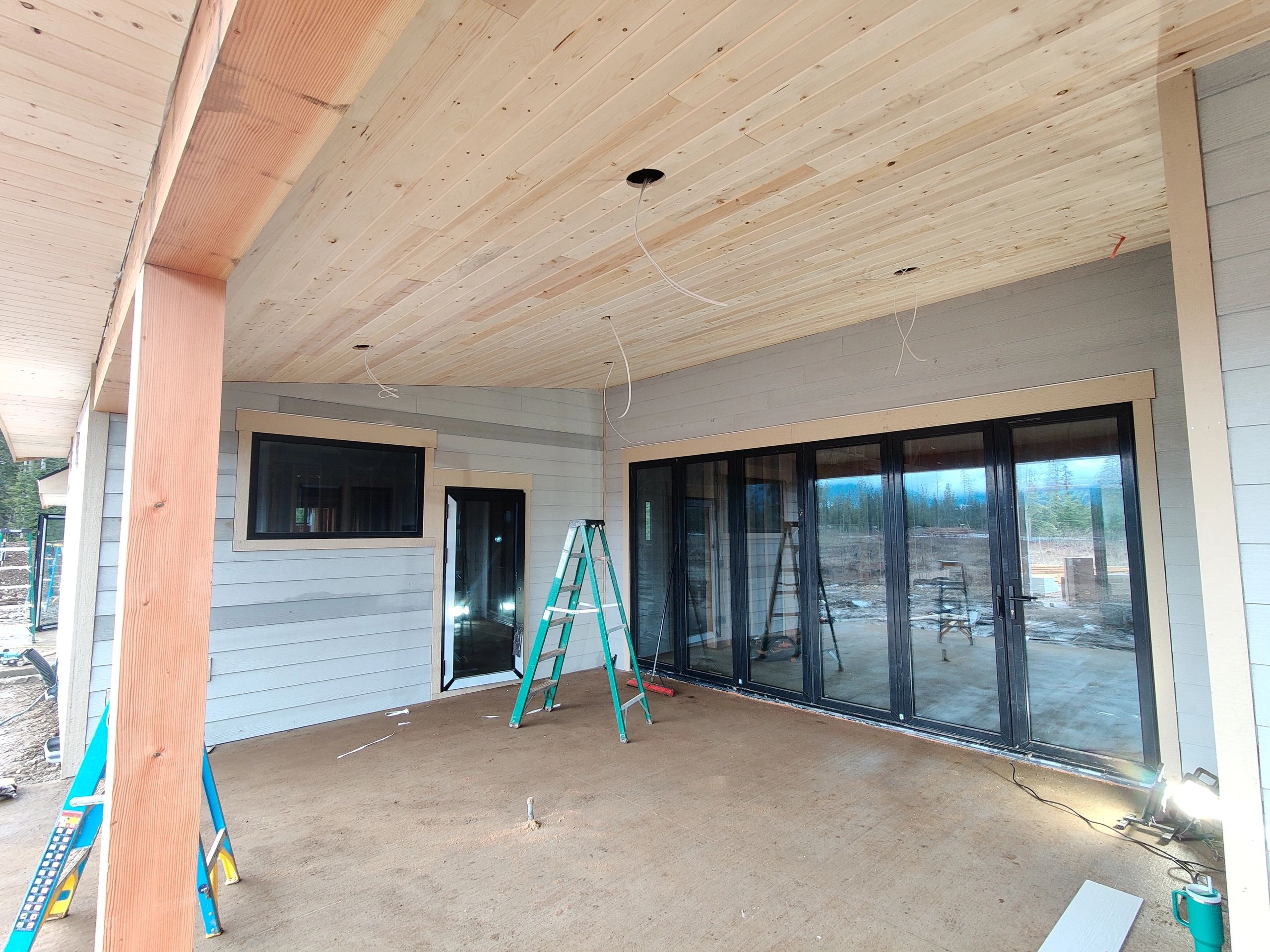 Covered patio project with wood ceiling detail and large sliding glass doors