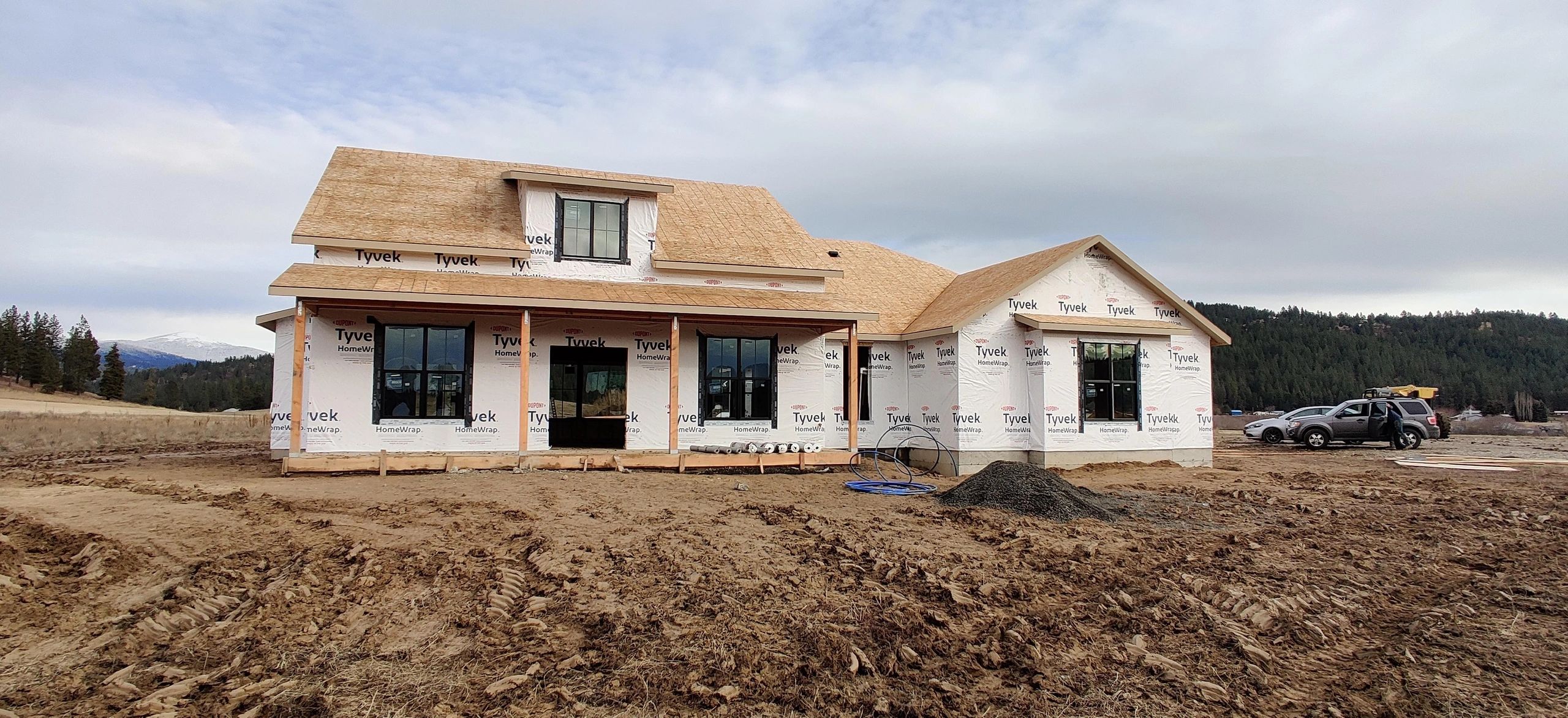 Hillside framed home with roof sheathing and exterior envelope in progress
