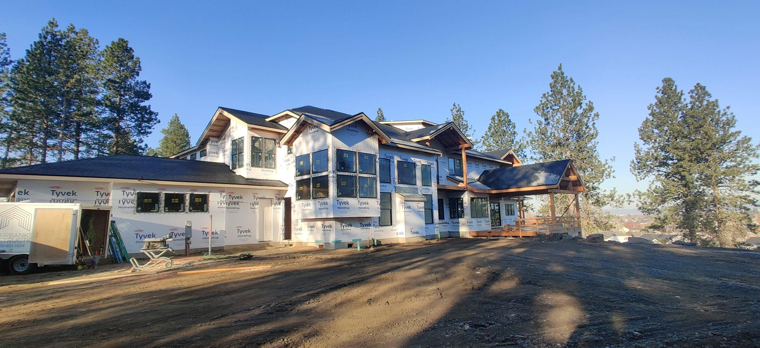 Large custom home exterior with framing and weather barrier in progress