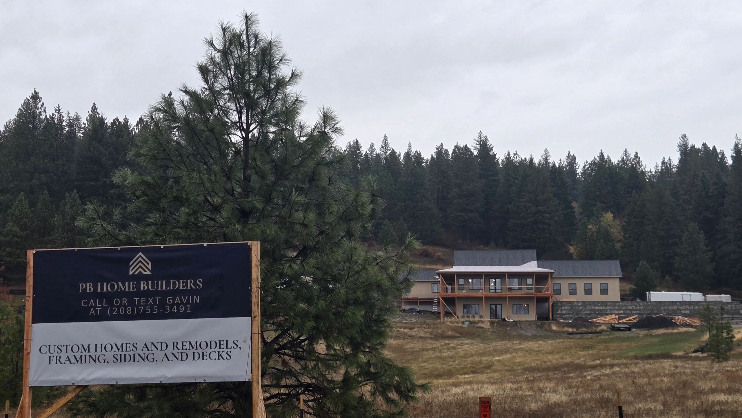 Rural build site with equipment, staging, and early project progress