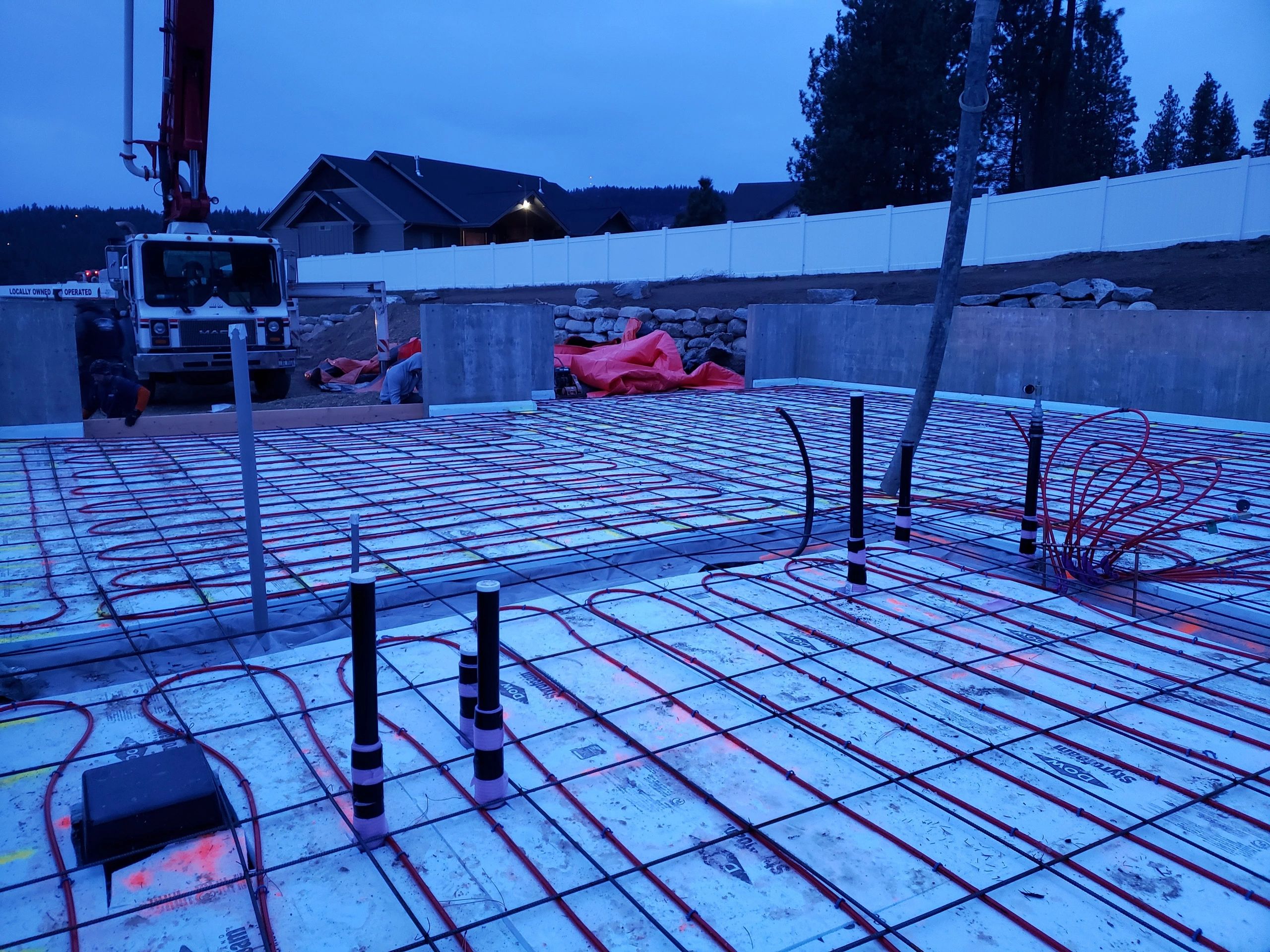 Foundation slab preparation with radiant tubing and reinforcement before concrete