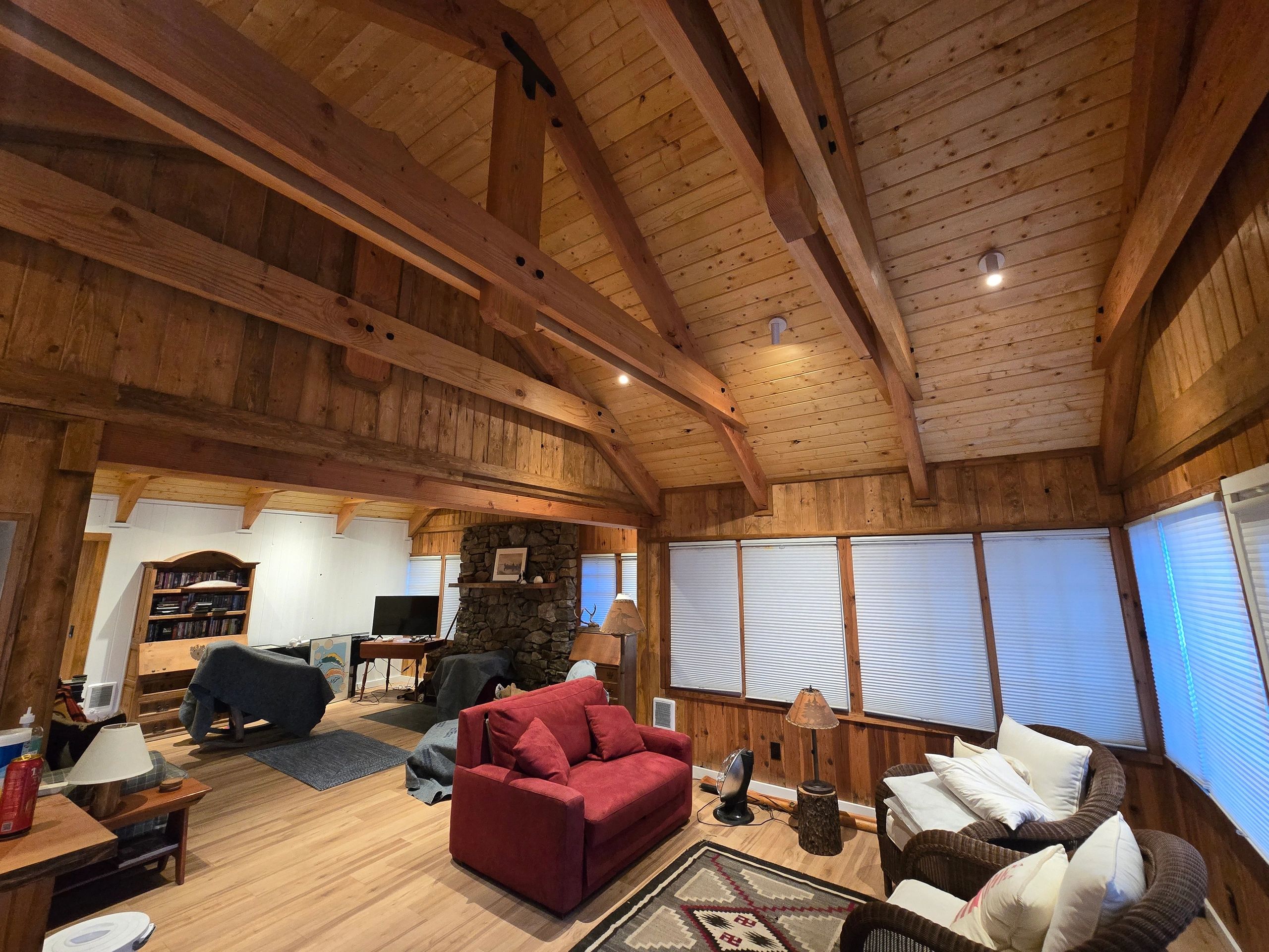 Finished timber great room with exposed beams and wood ceiling craftsmanship