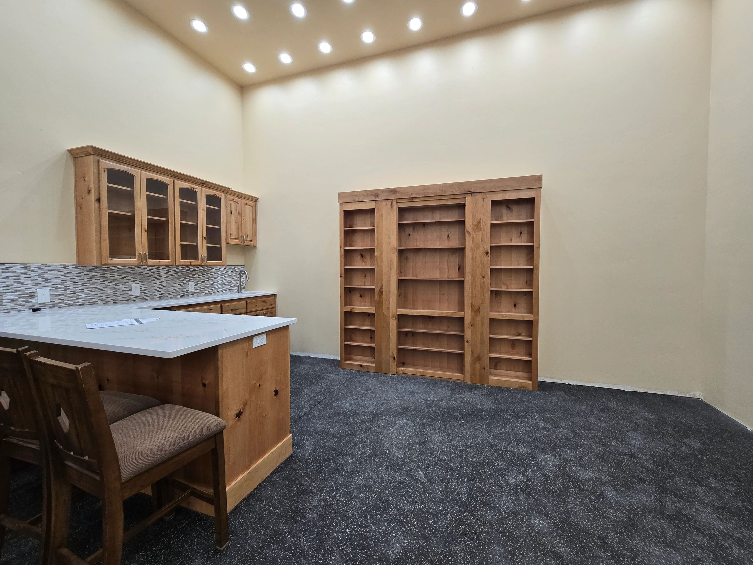 Custom trophy room with built-in shelving and ceiling lighting