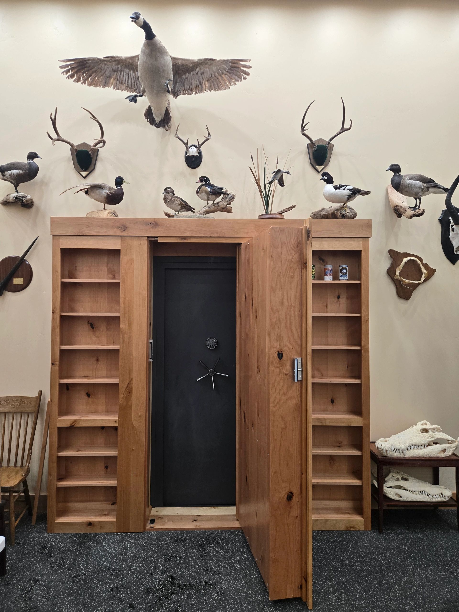 Custom trophy room entry with built-in wood storage and wall display
